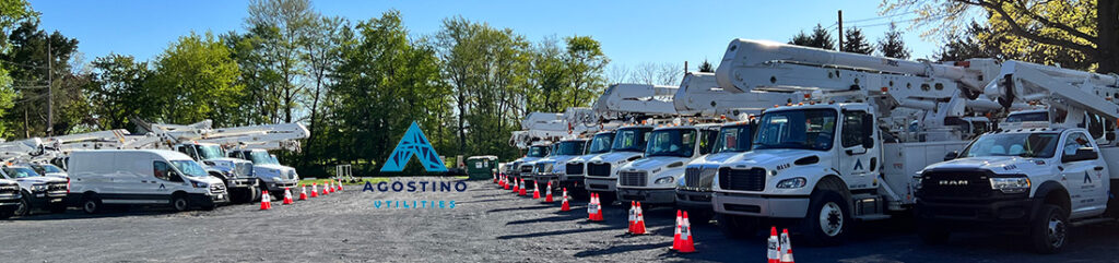 Agostino Utilities Branded Work Vehicles in Parking Lot