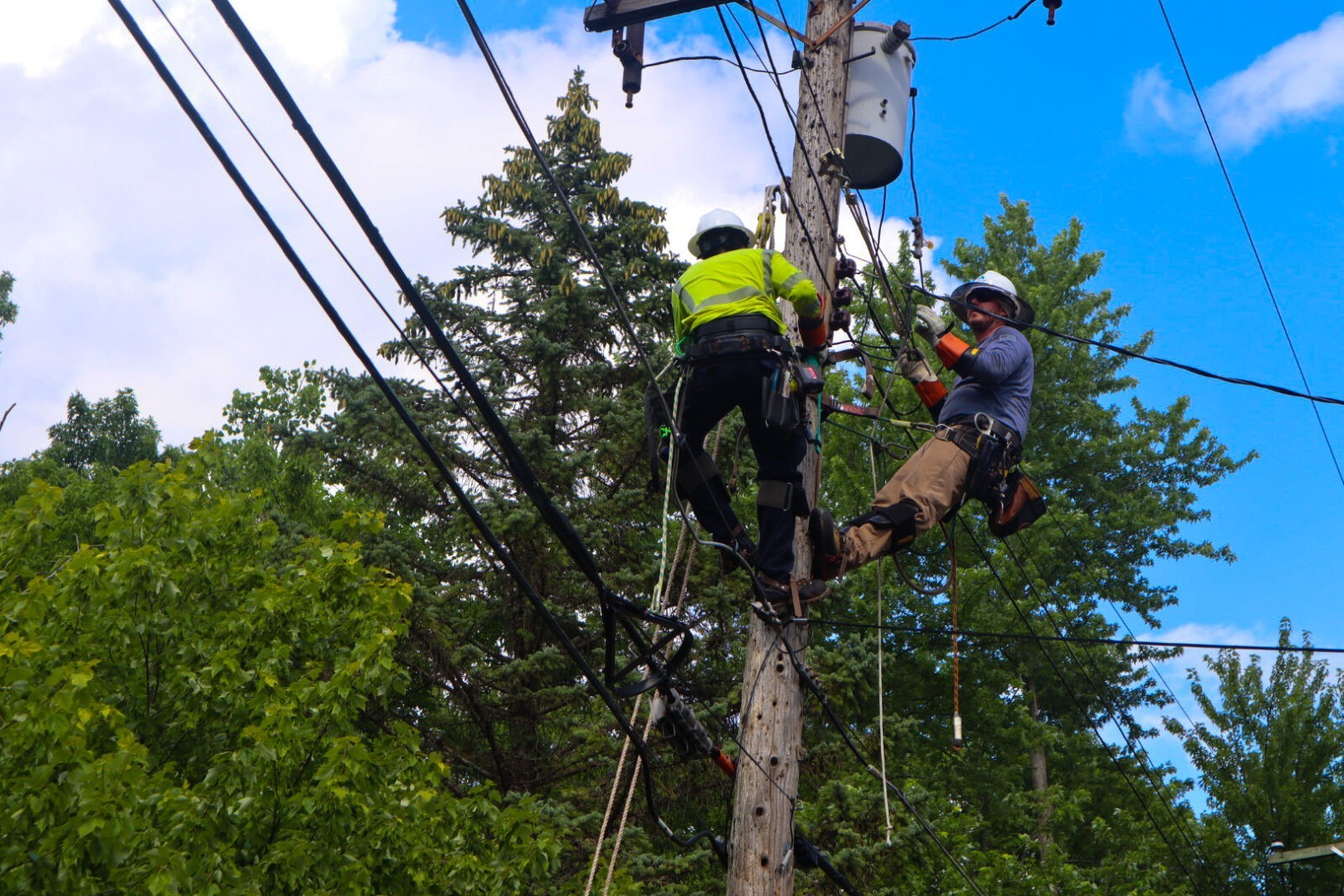 Two Men Working on a Utility Pole After Hurricane