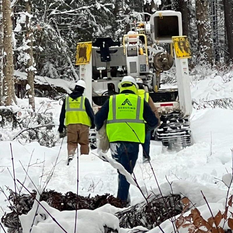 Two Men Walking in the Snow Towards a Truck